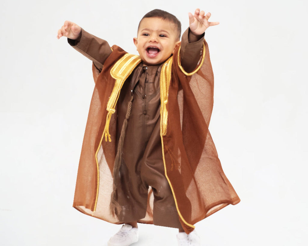 Child wearing a brown kandora with a brown arabic bisht 